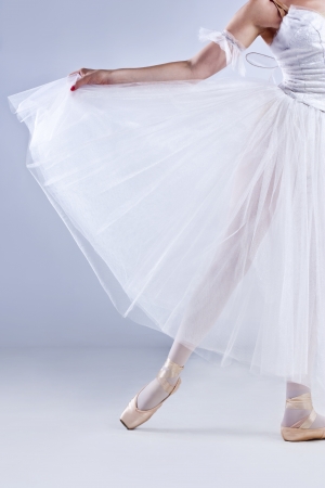 Beautiful ballerina posing, on gray studio background の写真素材