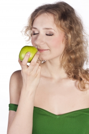 Smiling attractive woman offers a green appleの写真素材