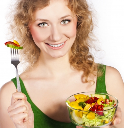 Woman with salad isolated on whiteの写真素材