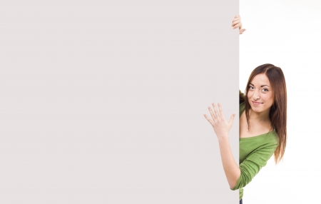 Happy woman holding a banner. isolated over a white backgroundの写真素材