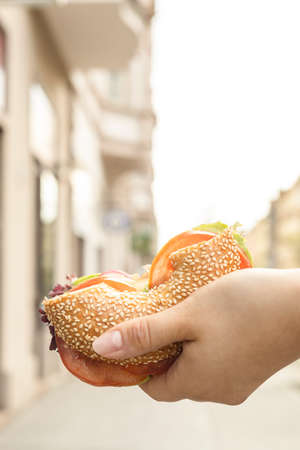 waitress holding a bagel in her handsの写真素材