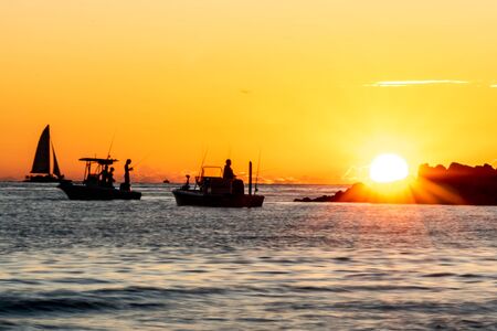 Silhouette of fishermen on the Gulf of Mexico at sunset
