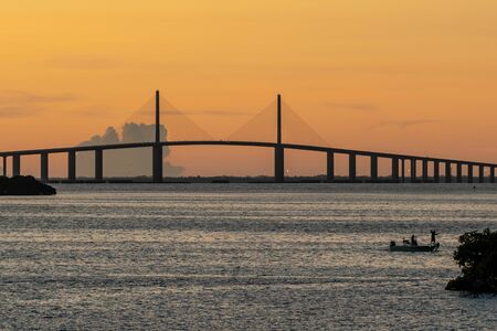 Tampa Bay, Florida and bridge at dawn with an orange skyの写真素材