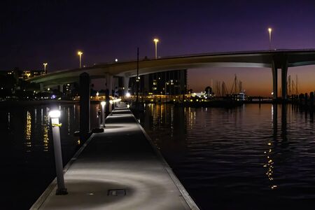 View of a harbor and bridge as the sun sets in Clearwater, Floridaの写真素材
