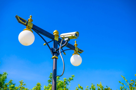 CCTV Camera Operating at park with blue skyの写真素材