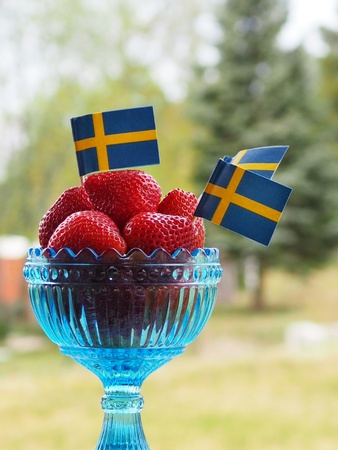 Strawberries with swedish flags for Swedens National Day or Midsummerの写真素材