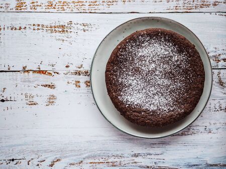 Delicious chocolate cake on white rustic wood