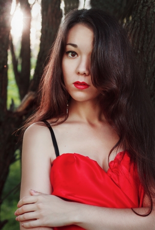 Portrait of beautiful girl in red dressの写真素材