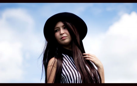 Girl in black hat and blue sky