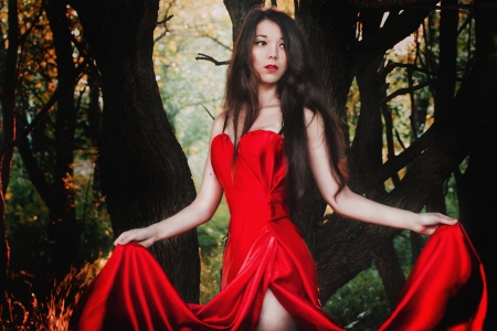 Beautiful girl in long red dressの写真素材