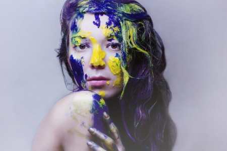 Beauty portrait of a girl painted blue and yellowの写真素材