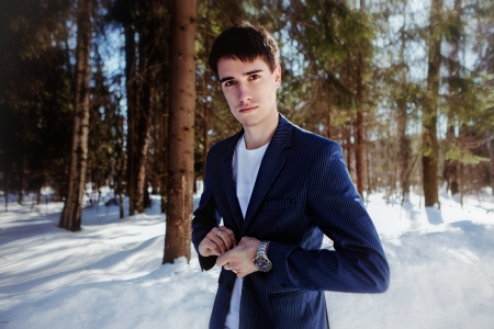 Portrait of a man in suit in snow forestの写真素材
