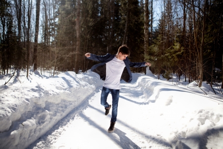 Handsome man dancing on snow backgroundの写真素材