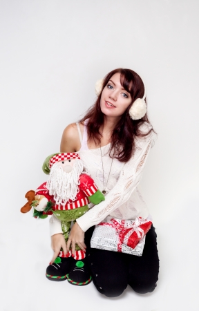 Happy girl with christmas present on white backgroundの写真素材