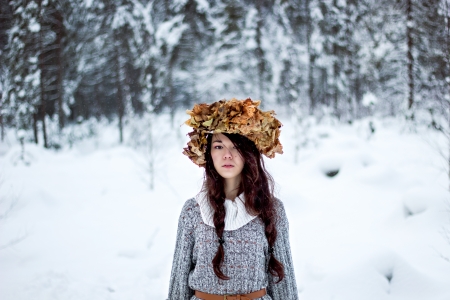 Forest woman with autumn leaves in white snow winter の写真素材