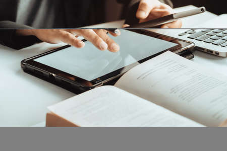 Business man use digital tablet.pointing device screen and holding digital Pen tablet on desk at...