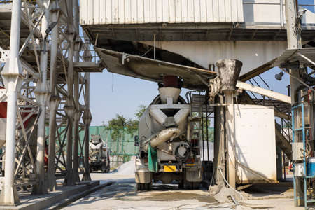 Mixer concrete trucks waiting to load concrete mixing at batching factory for go to the casting...