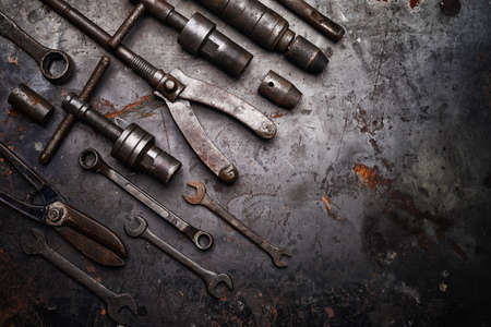Flat lay Old hand tools ,Pliers screwdriver wrench rusted iron metal tools on Steel plate at garageの写真素材