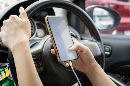 Woman driver using a smartphone in car