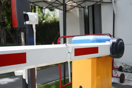 Damaged Automatic Barrier Gate in the Parking lot , Security system for building and car entrance...