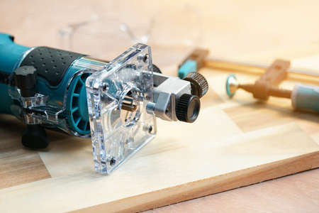 Electric Trimmer ,Wood Router Tools on Walnut Plywood in workshop, woodworking Handicraft and diy concept .selective focusの写真素材