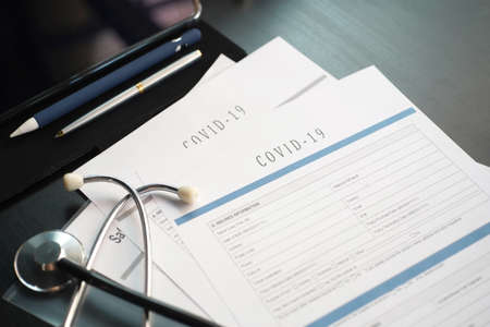 Coronavirus or COVID19  insurance policy document on desk, Health Care Insurance Plan concept.の写真素材