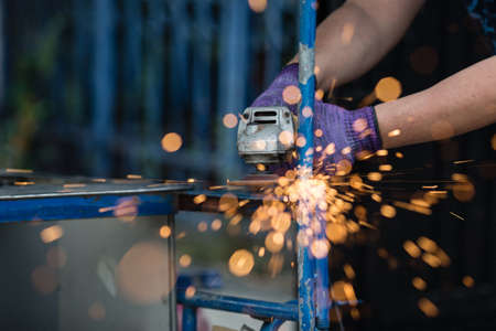 Hand of workers men Working on a steel with grinder machine. selective focus