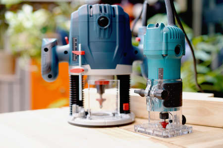 power tool , Electric Trimmer ,Wood Router Tools on wood background, DIY maker and woodworking concept. selective focusの写真素材