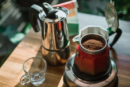 Finely ground coffee and vintage coffee maker moka pot on wooden table at home ,Selective focus.の写真素材