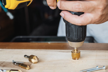 Carpenter use countersink bit to drill both a pilot hole and use countersink bit to recess the head...