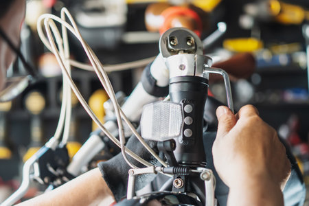 Technician makes adjustments to handlebar Stem on a folding bicycle working in workshop , Bicycle Repair and maintenance conceptの写真素材