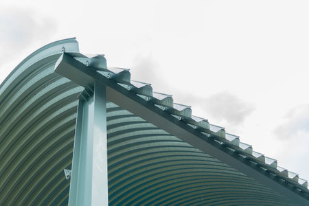 Texture of metal sheet roof. Curved metal roofing panels view from below