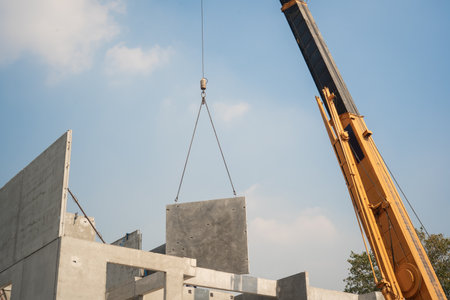 mobile crane lifting precast concrete wall panel to installation new building at Construction site .の写真素材