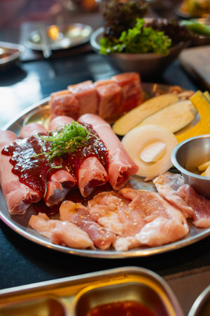 Tray with fresh pork raw and vegetables,ingredients for marinated , ready for cooking in Korean barbecue restaurant.の写真素材