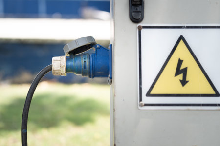 Industrial sockets and plug on outdoor electrical distribution box at Construction site.