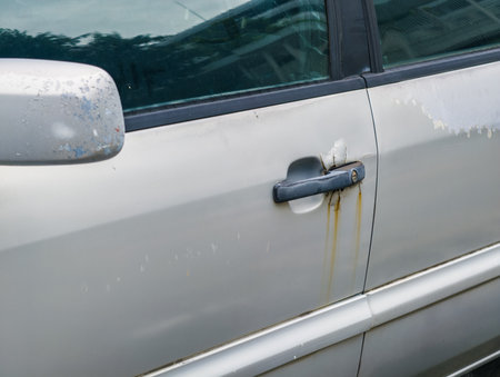 Rusted car door with peeling paint, rust damage on car door handle.Car care and body paint conceptの写真素材