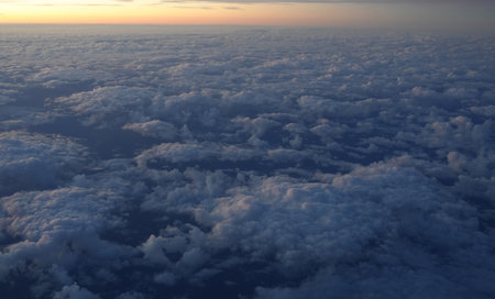 View of clouds and sky in the morning from a plane window Concept of flight and travel by plane