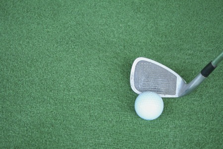 Golf clubs and golf balls on green artificial grass At the golf driving rangeの写真素材