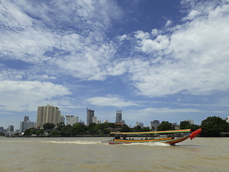 BANGKOK, THAILAND - June 13, 2017: Boats and buildings on the Chao Phraya River in the blue sky in Bangkok, Thailandのeditorial素材
