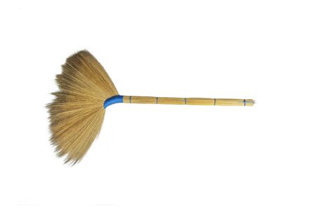 Old traditional hand made broom,from flowers and grass are hand-made on white backgroundâ.Blue braided rope tied with dried flowers to make an ancient broomの写真素材
