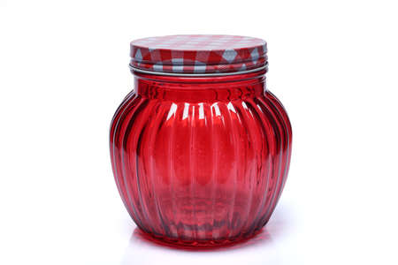 The glass jar, red color with metal lid isolated on white backgroundの写真素材