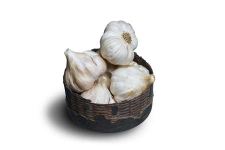 garlic in the old basket on isolated white background with clipping path