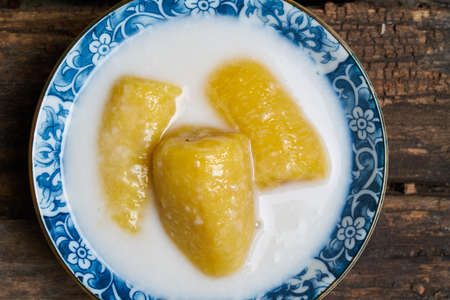 Thai dessert, banana in coconut cream on top viewの写真素材
