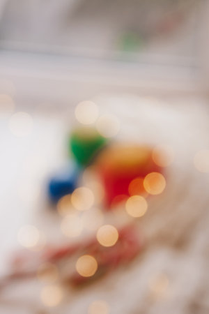 Blurred candles as balls with Christmas decoration on the white and knitted background. New year or Christmas holiday concept, holidays cardの写真素材