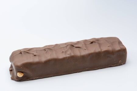 Chocolate bar with peanut on a white backgroundの写真素材