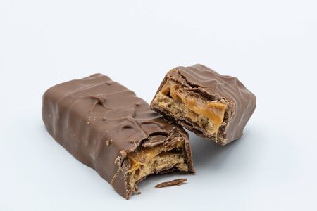 Chocolate bar with caramel inside on a white backgroundの写真素材
