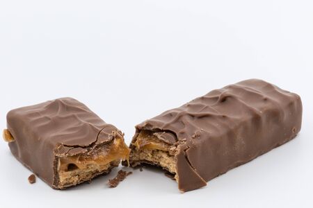 Chocolate bar with caramel inside on a white backgroundの写真素材