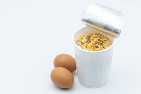 Instant noodle with egg on a white backgroundの写真素材