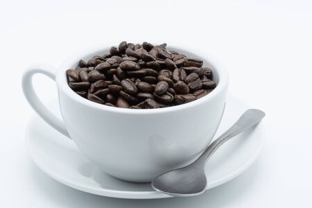 Coffee seed in a white ceramic cup on a white backgroundの写真素材