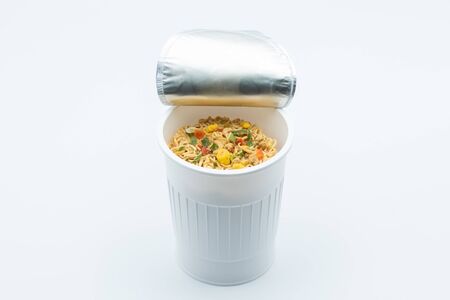 Instant noodles in a plastic cup on a white backgroundの写真素材